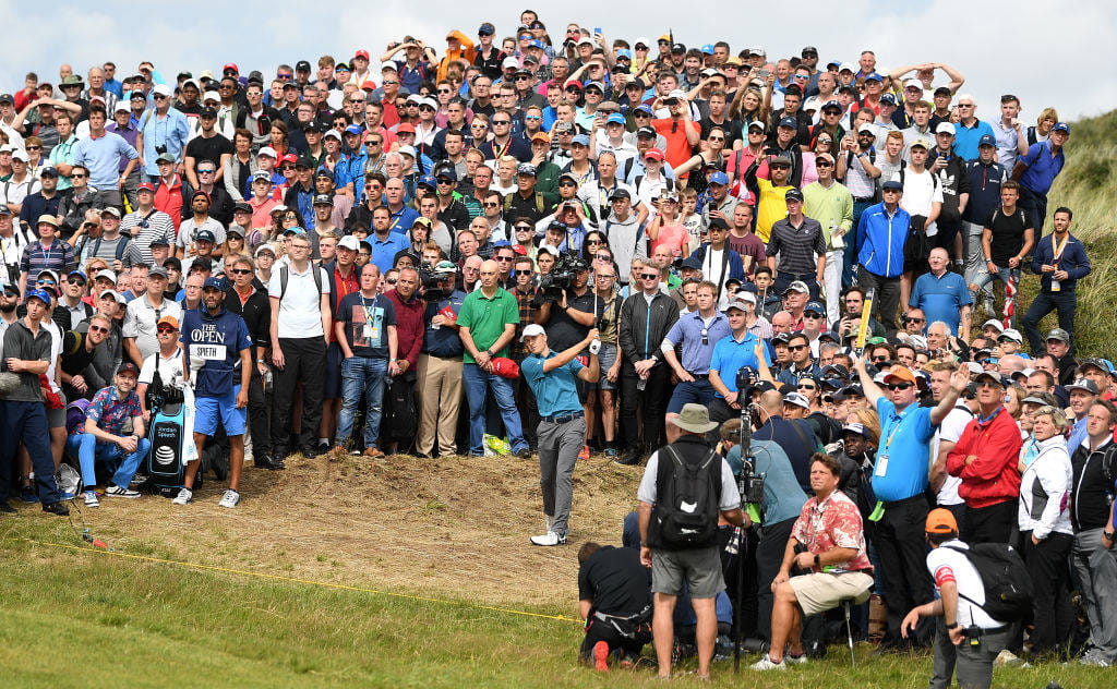 Spectators watch on as eventual Champion Golfer Jordan Spieth hits a shot at The Open at Royal Birkdale n 2017